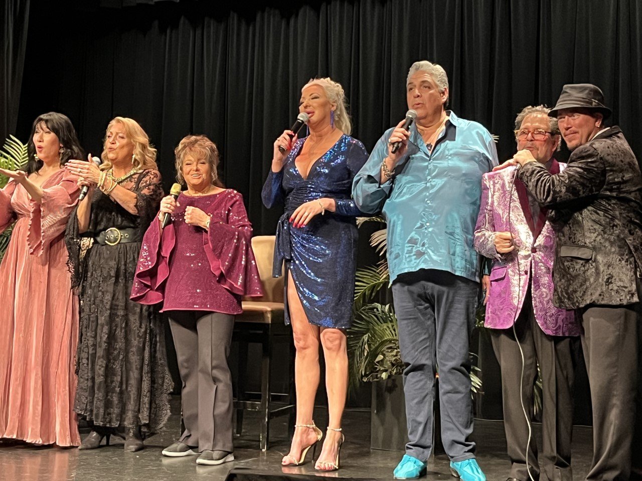 A group of people presenting on a stage.