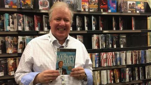 Chris Korman is happy holding a magazine.