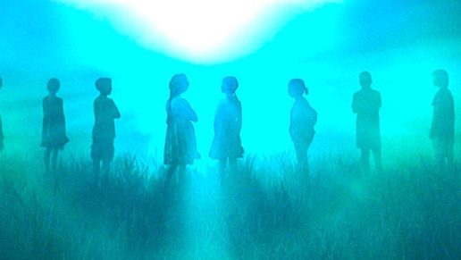 Silhouette of kids in a grassy area.