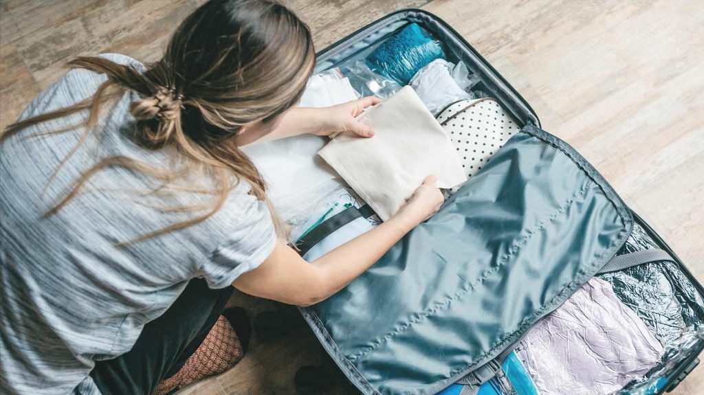 A woman preparing her baggage.